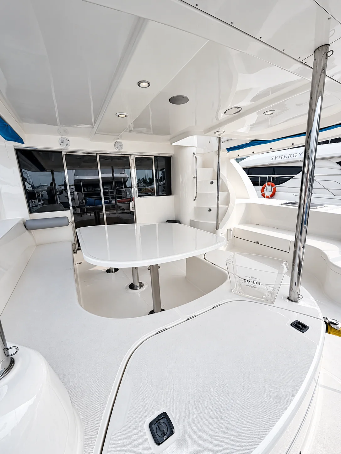 Covered outdoor dining area aboard One Lotus with a table and seating